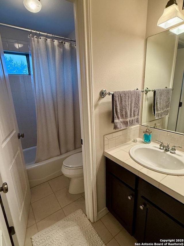 full bathroom with toilet, vanity, shower / tub combo with curtain, and tile patterned floors