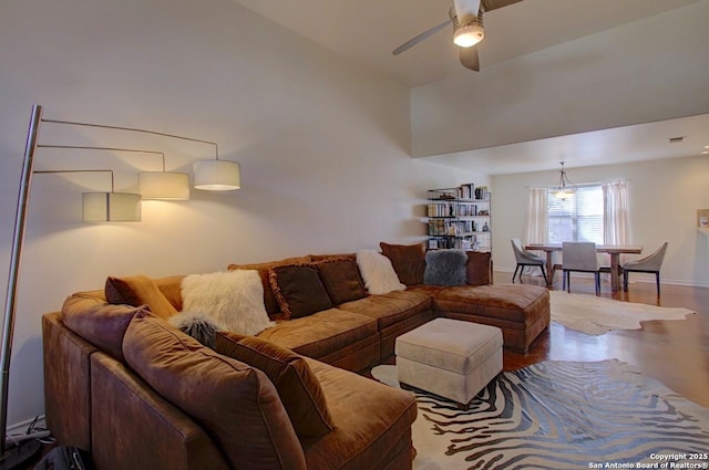 living room featuring high vaulted ceiling, baseboards, and a ceiling fan