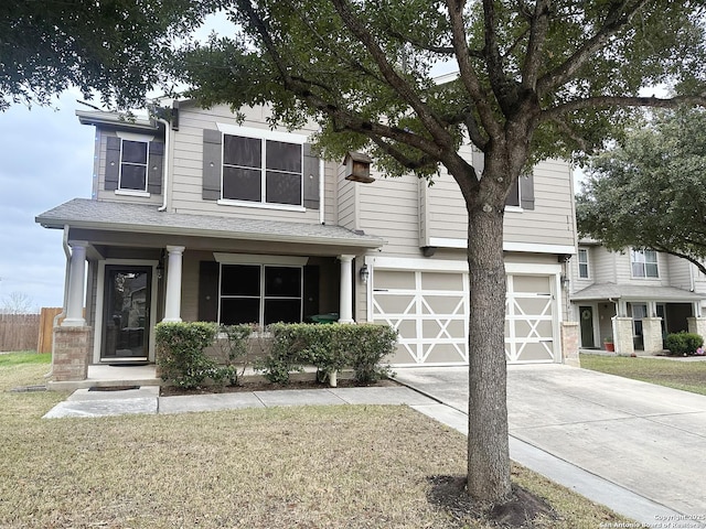 view of front of home featuring a garage, a front lawn, and concrete driveway