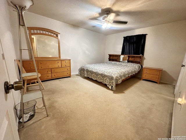 carpeted bedroom with a textured ceiling and a ceiling fan