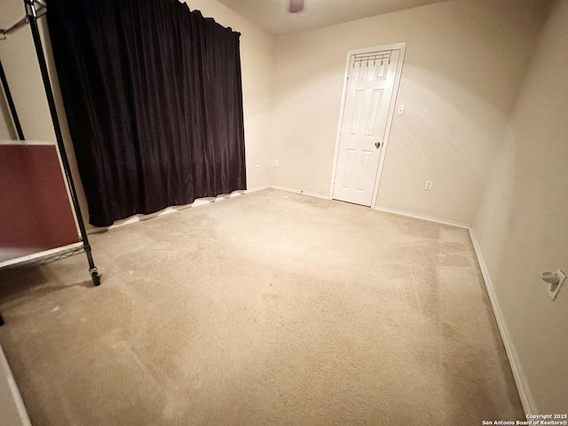 empty room with carpet flooring and baseboards