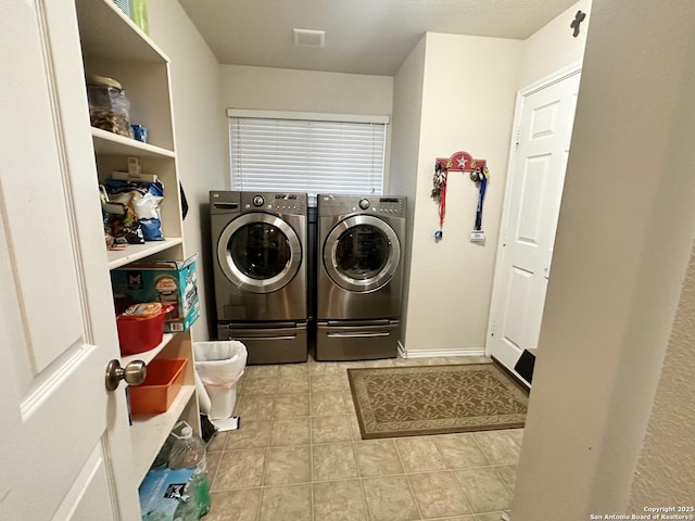 laundry area with laundry area, visible vents, separate washer and dryer, and tile patterned floors