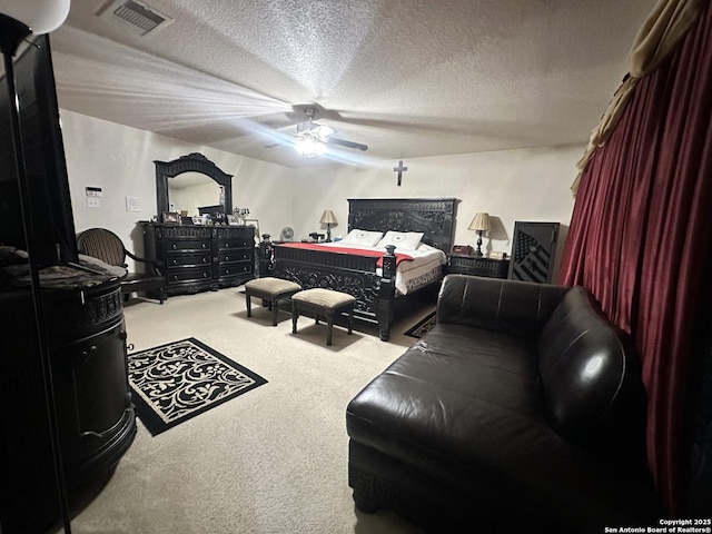 bedroom featuring visible vents, ceiling fan, a textured ceiling, and carpet flooring