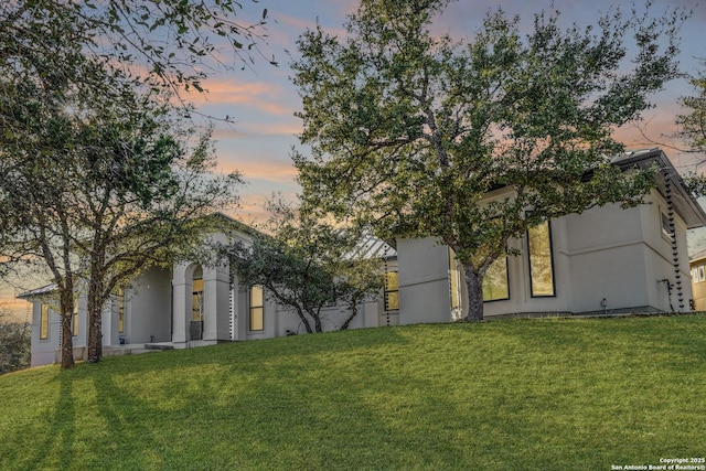 exterior space featuring a yard and stucco siding