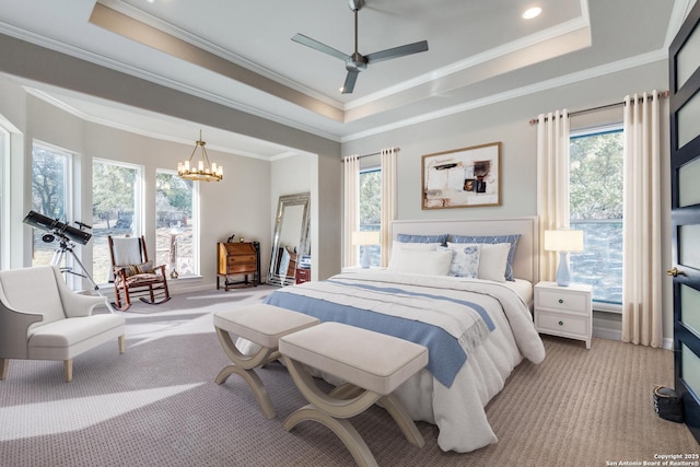 bedroom with ornamental molding, a tray ceiling, light carpet, and an inviting chandelier