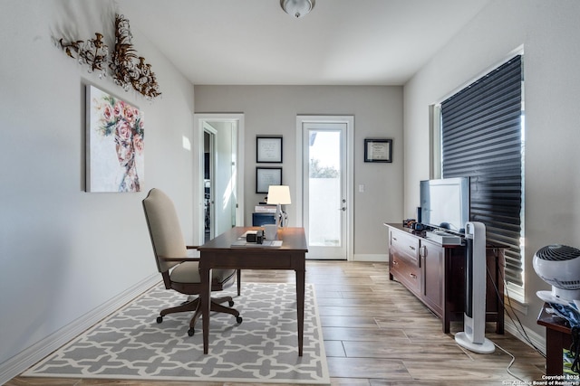 home office featuring light wood-style floors and baseboards