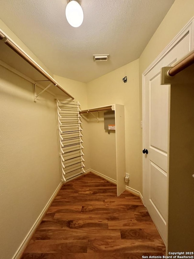 spacious closet featuring visible vents and wood finished floors