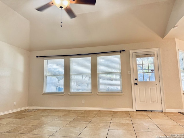 interior space with light tile patterned floors, baseboards, lofted ceiling, and a ceiling fan