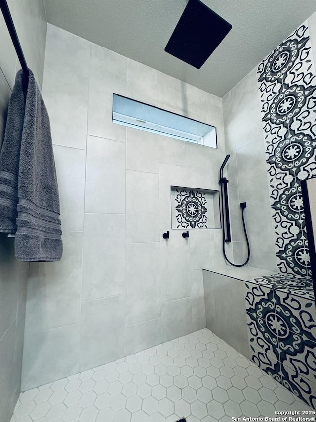 bathroom featuring a tile shower