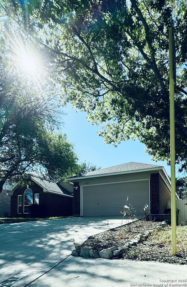 garage featuring concrete driveway