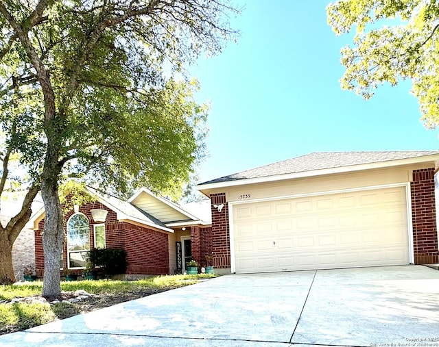 ranch-style house featuring brick siding, concrete driveway, and a garage