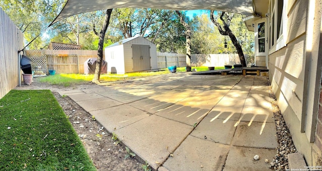 view of patio / terrace with a storage shed, a fenced backyard, and an outdoor structure