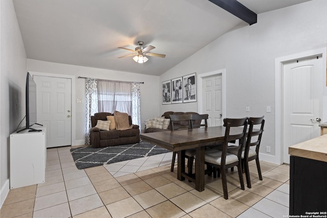 dining room with light tile patterned floors, ceiling fan, baseboards, and vaulted ceiling with beams