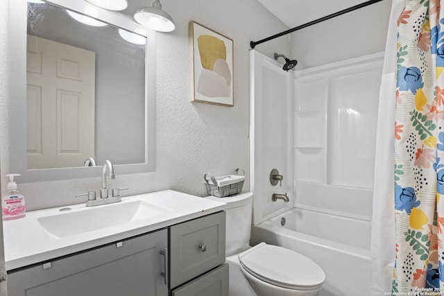 bathroom featuring shower / bath combo, a textured wall, vanity, and toilet