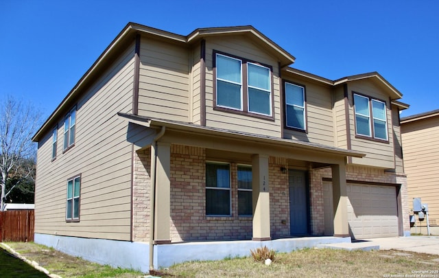 view of front of property featuring concrete driveway, brick siding, fence, and an attached garage