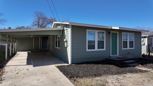 view of front of home featuring entry steps, concrete driveway, an attached carport, and crawl space