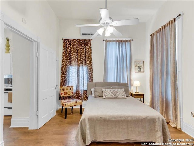 bedroom with ceiling fan and wood finished floors