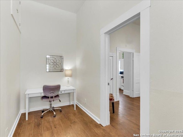 office area featuring baseboards and wood finished floors