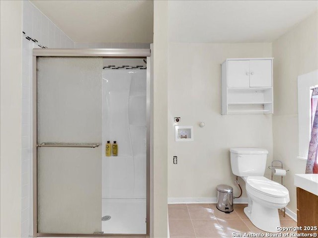 full bathroom featuring toilet, a shower stall, vanity, and tile patterned floors