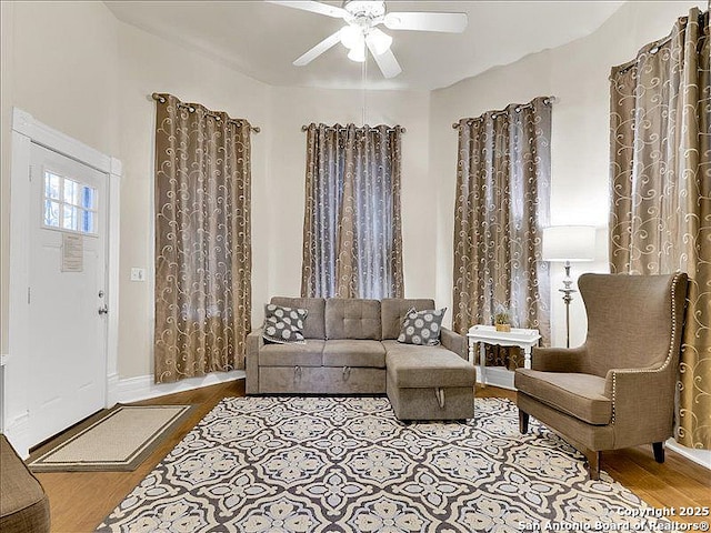 living area featuring ceiling fan and wood finished floors