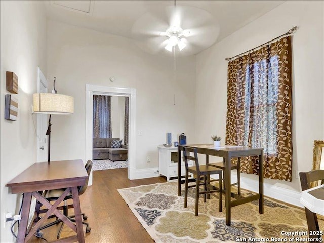 dining space with ceiling fan, baseboards, and wood finished floors