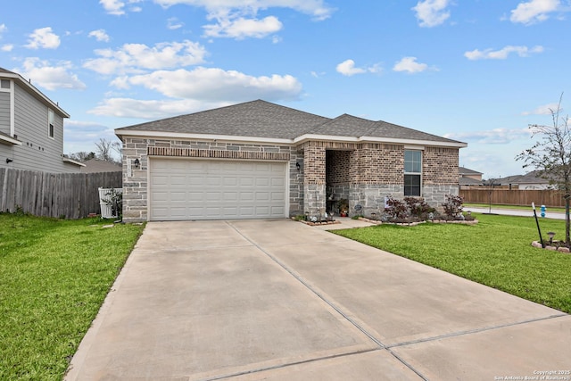 view of front of property featuring a shingled roof, an attached garage, fence, driveway, and a front lawn