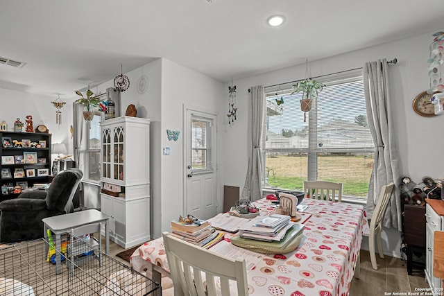 dining space with visible vents, plenty of natural light, and wood finished floors