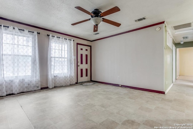 empty room featuring visible vents, crown molding, and light floors