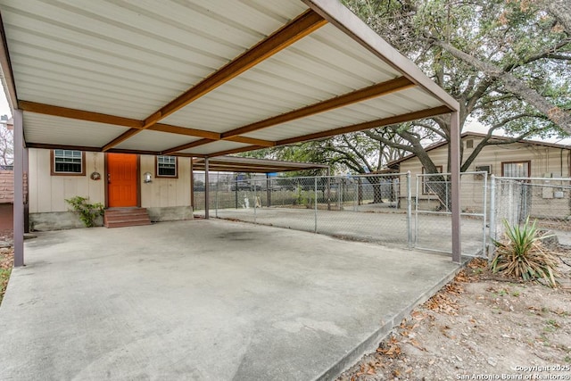 view of patio / terrace with entry steps, a gate, fence, and a carport