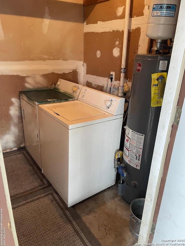 laundry room with laundry area, water heater, and independent washer and dryer