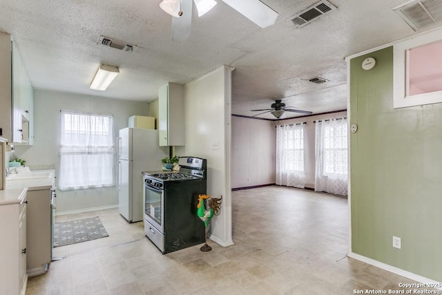 kitchen featuring ceiling fan, visible vents, and stainless steel range with gas stovetop