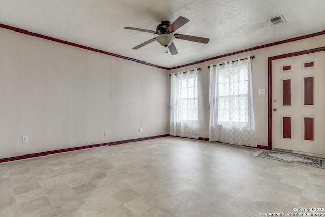 empty room with baseboards, visible vents, a textured ceiling, crown molding, and light floors