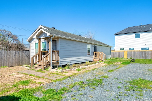 back of property featuring a fenced backyard