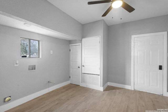 washroom featuring a ceiling fan, light wood-type flooring, washer hookup, and baseboards