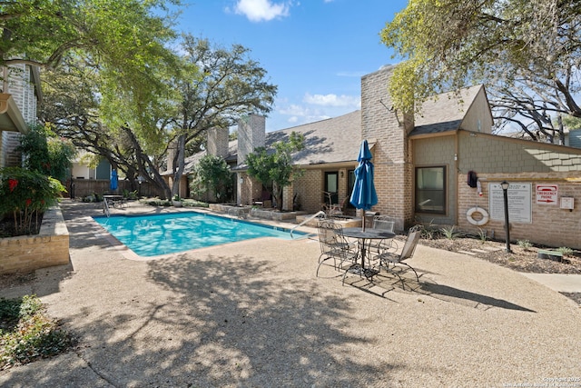 community pool featuring a patio area and fence