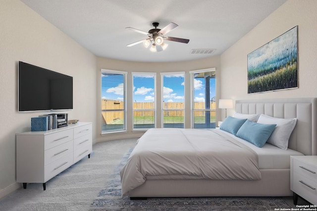 bedroom featuring light carpet, ceiling fan, and visible vents