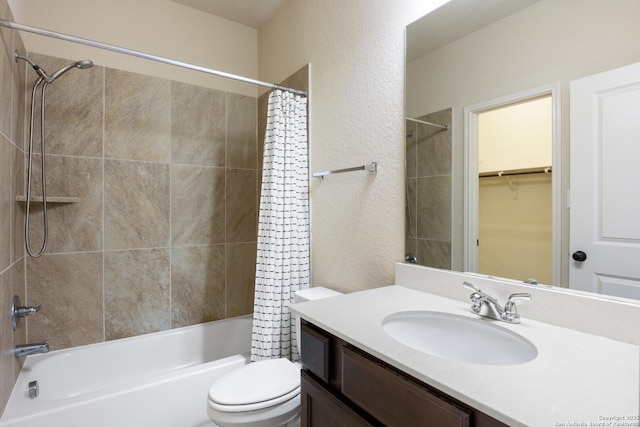 full bathroom with shower / tub combo, a textured wall, vanity, and toilet