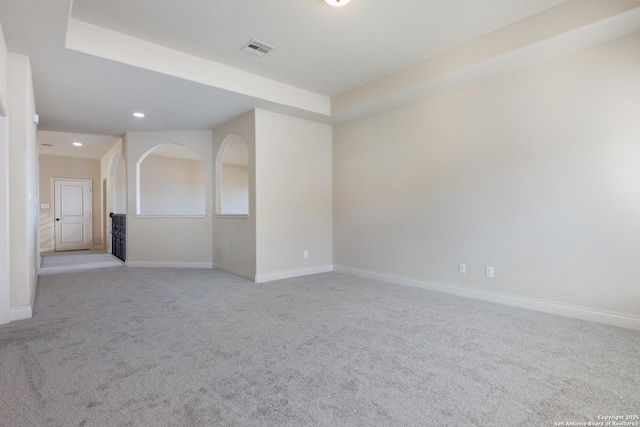 empty room with recessed lighting, baseboards, visible vents, and light colored carpet