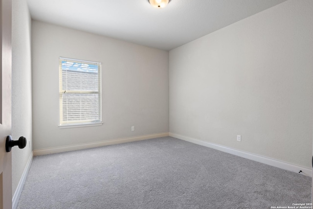 spare room with carpet floors and baseboards