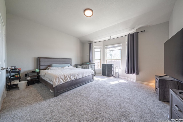 bedroom featuring carpet floors, lofted ceiling, and baseboards