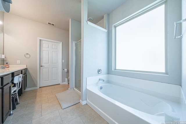 bathroom featuring a garden tub, vanity, visible vents, a shower stall, and tile patterned floors