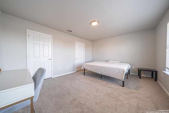 bedroom with carpet, visible vents, and baseboards