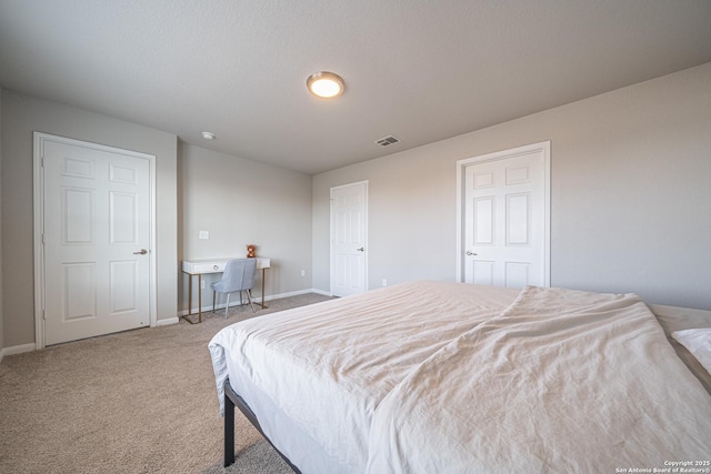 bedroom featuring baseboards, visible vents, and carpet flooring