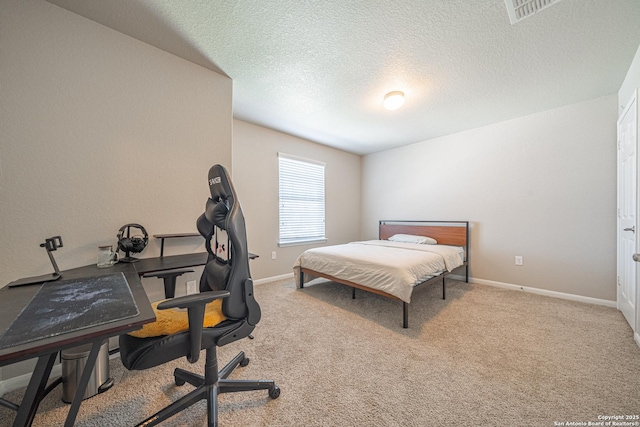 bedroom with carpet floors, visible vents, baseboards, and a textured ceiling