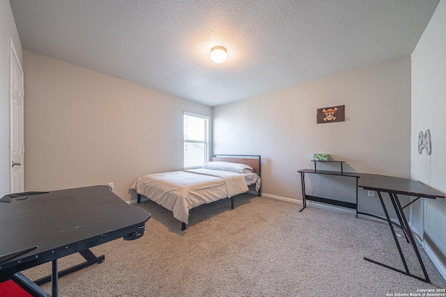 bedroom featuring carpet flooring, a textured ceiling, and baseboards