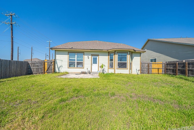 back of house with a fenced backyard, a patio, and a yard