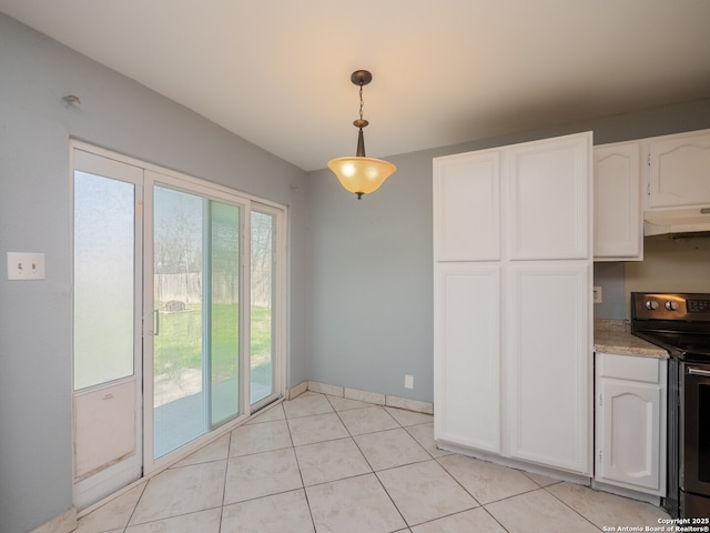 unfurnished dining area featuring light tile patterned flooring and baseboards