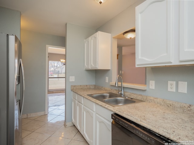 kitchen featuring stainless steel refrigerator with ice dispenser, light tile patterned floors, white cabinets, a sink, and dishwasher