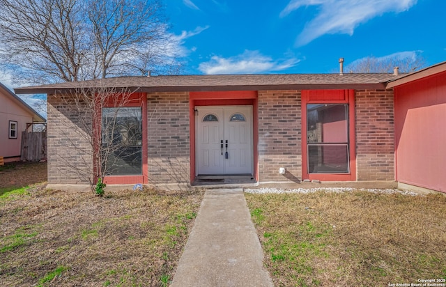 property entrance featuring brick siding