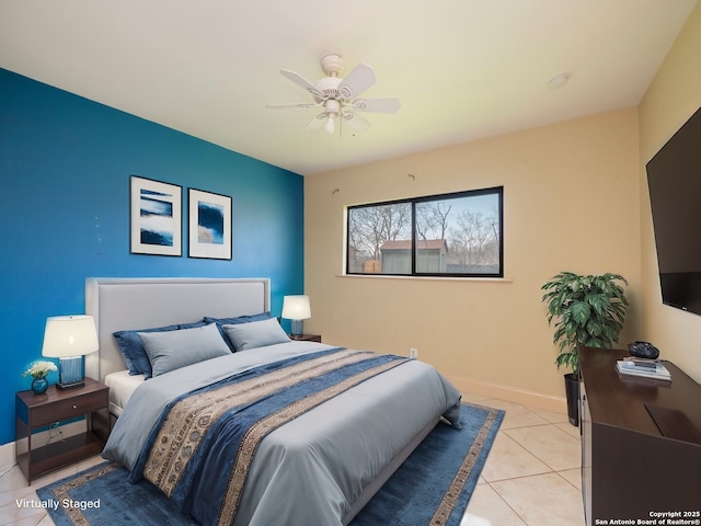 bedroom with light tile patterned floors, a ceiling fan, and baseboards